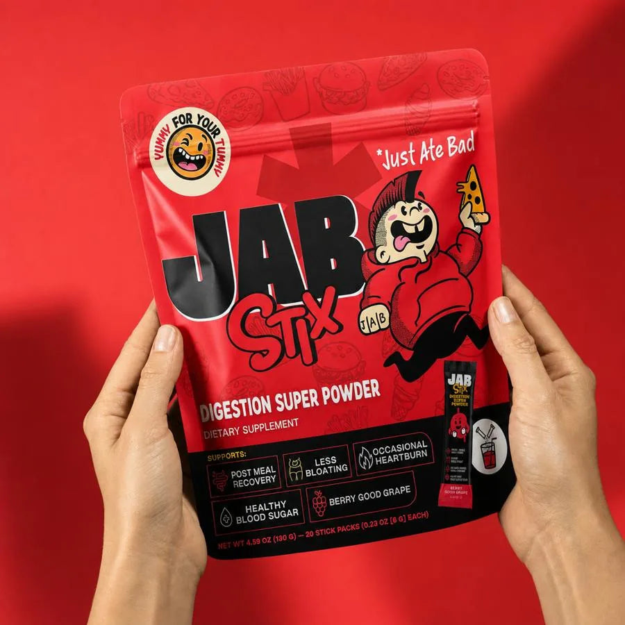 Hands holding a pouch of JAB Stix digestive super powder