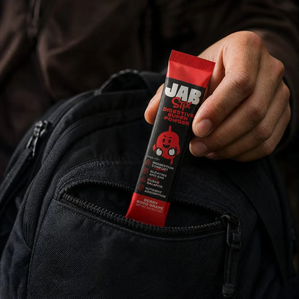 A hand pulling a JAB Stix out of a backpack pocket